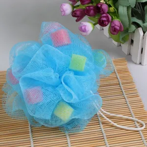 Detailed view of soft blue mesh bath sponge with colorful sponge blocks for gentle daily shower cleaning.