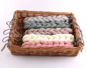 Detailed view of colorful braided mesh shower bath sponges neatly placed in a wicker basket.