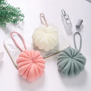 Detailed shot of large Korean style soft mesh bath sponge poufs in multiple colors with cord.
