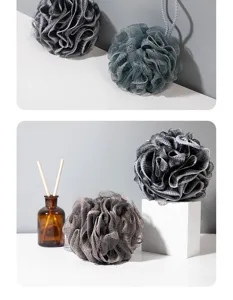 Dark gray soft mesh bath sponge, fluffy shower loofah for comfortable body cleaning and bubble bath.