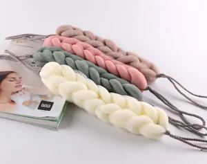 Detailed view of soft braided mesh bath body scrubbers in multiple colors with hanging ropes.