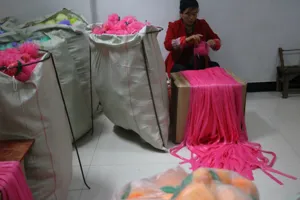 Factory workshop production detail showing raw materials and mesh manufacturing for bath sponges.