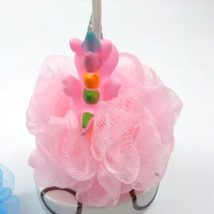 Close-up detail of the cute pink cartoon animal bath sponge, soft mesh netting texture.