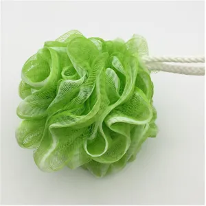 Green mesh bath sponge detail, soft shower puff close up, fluffy loofah for body cleaning.
