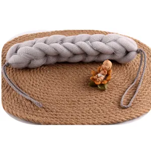 Grey braided mesh bath sponge, long exfoliating body scrubber with comfortable handle for shower.