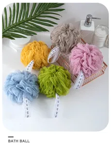 Detailed shot of colorful bath sponge balls with lace hanging straps for daily body cleaning.