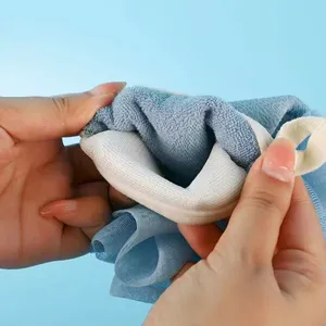 Dual-sided exfoliating bath glove for body scrubbing, comfortable mesh shower mitt for home use.