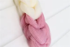 Detailed close-up showing the textured mesh structure and dual-color braid of the bath sponge.