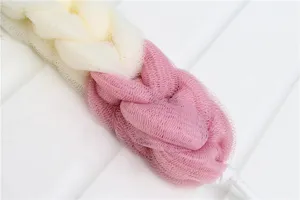 Detail shot of dual-color braided mesh bath sponge, soft texture, convenient hanging rope.