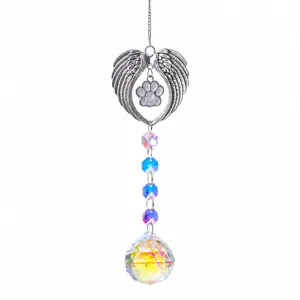 Crystal suncatcher detail showing angel wings, paw print pendant, and colorful prisms.