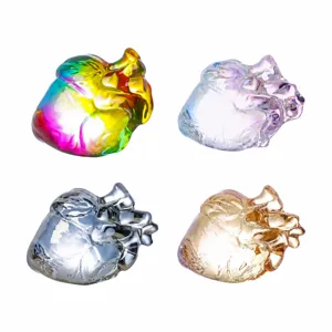 Close up detail of crystal anatomical heart ornament, glossy electroplated finish, home decor.