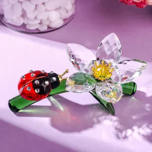 Detailed close-up of crystal ladybug and flower ornament, sparkling desktop decor figure.