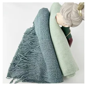 Soft cashmere-feel winter tassel scarf detail showcasing cozy knit texture and elegant drape.