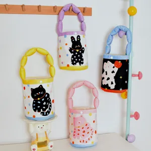 Cute polka dot cat canvas bucket bag with soft padded handle, playful kids handbag for daily use.