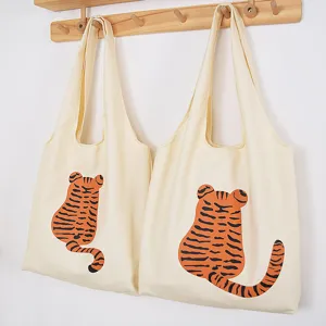 Canvas tote bag for women, casual shoulder shopping bag with cute cartoon tiger design.