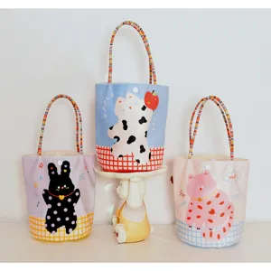 Cute cartoon print canvas tote bag with colorful braided handles for daily shopping or school.