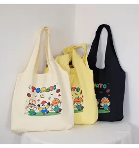 Canvas tote bag featuring cute tomato cartoon print, casual shoulder bag style for daily use.