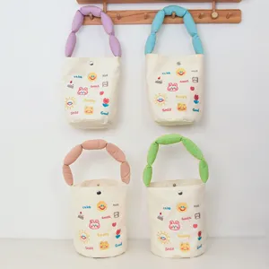 Canvas bucket bag with cute embroidered cartoon patterns and colorful bubble handles for daily use.