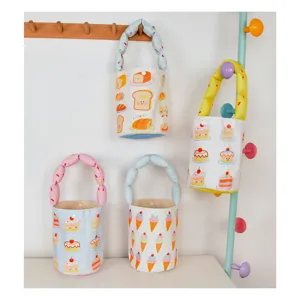 Cute cartoon print canvas bucket bag with soft puffy handle, perfect daily handbag for kids.