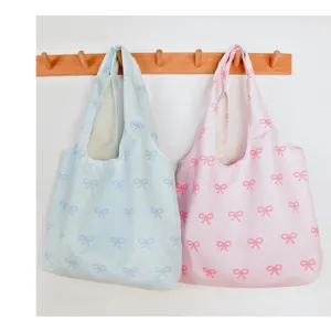 Detail view of the lightweight bow printed canvas tote bag, featuring large capacity.
