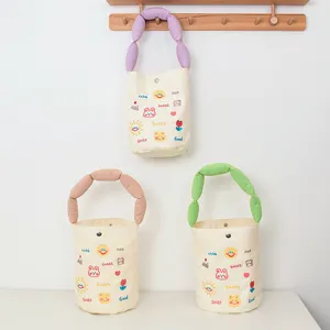 Canvas bucket bag with cute cartoon embroidery and colored puffy handle, stylish gift handbag.