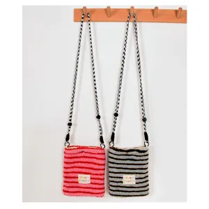 Plush cross-body phone bag featuring striped design and adjustable strap. Detail view.
