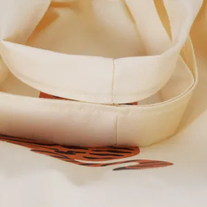 Close-up detail of beige canvas tote bag handle, durable fabric and clean stitching work.