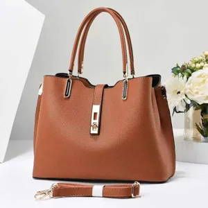 Elegant brown tote bag detail showcasing premium textured leather and refined gold hardware lock.