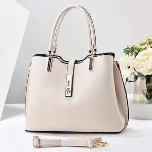 Detail view of minimalist retro women's handbag, stylish beige tote bag with chic gold hardware.