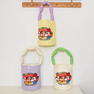 Canvas bucket bag with cartoon print and puffy padded strap, large capacity cute handbag for women.