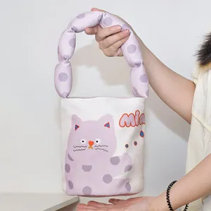 Canvas bucket handbag with padded puffed handle and cute purple cat print style.