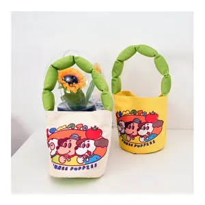 Cute cartoon canvas bucket bag with green stuffed handle, playful dog print for daily casual use.