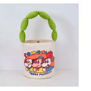 Close-up detail of the cute canvas bucket bag featuring playful cartoon puppy graphic print.