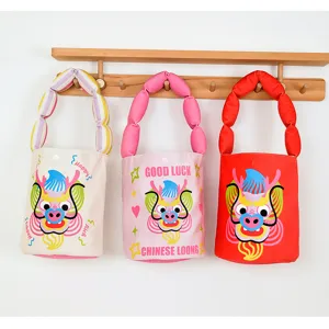 Cute cartoon dragon canvas bucket bag with puffy strap, festive Year of the Dragon handbag.
