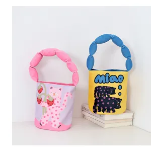 Cute cartoon print padded strap bucket bag, stylish canvas handbag for women and kids detail view.