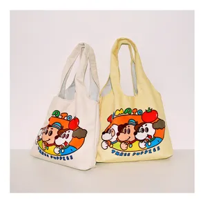 Detailed view of cute cartoon canvas tote bag, large capacity shoulder bag with graphic print.