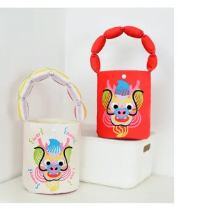 Detailed view of cute cartoon dragon canvas bucket bag with soft padded handle, festive design.