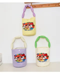 Canvas bucket bag detail showing cute cartoon puppy print and soft stuffed handle.