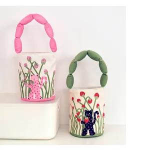 Cute cotton-padded handle bucket bag featuring whimsical cat and strawberry print design.