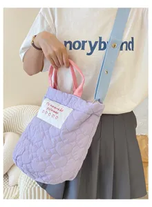 Purple quilted shoulder bag with pink handles and blue strap, casual daily tote bag detail.