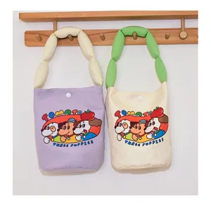 Canvas bucket bag with padded handle and cute cartoon print detail, casual tote design for daily use.