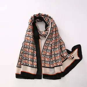 Detailed view of the geometric print scarf showcasing fabric texture and edge contrast design.