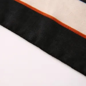 Close-up detail view of women's stylish color block scarf fabric showing neat texture.