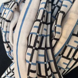 Close-up detail of women geometric print scarf, lightweight breathable fabric, stylish daily accessory.