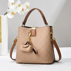 Stylish brown bucket bag with top handle and shoulder strap for women, trendy chic handbag.