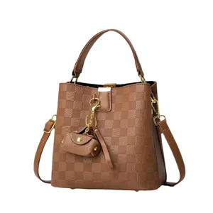 Classic brown checkerboard bucket bag with top handle, detachable strap, and mini pouch charm.