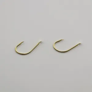 Gold fishing hooks barbed detail close up view, sharp metal points for traditional angling.