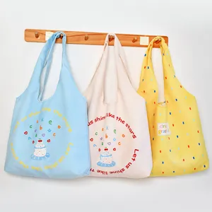 Canvas tote bag detail showing cute print design and large capacity for daily student use.