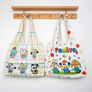 Canvas tote bag detail view, cute cartoon animal prints and polka dot design for daily use.