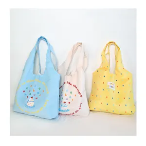 Close-up of cute large capacity canvas tote bag with graphic print for daily student style.